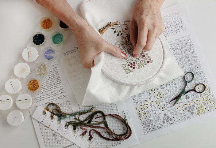 A close up of a person using an embroidery hoop at High Street Quilting